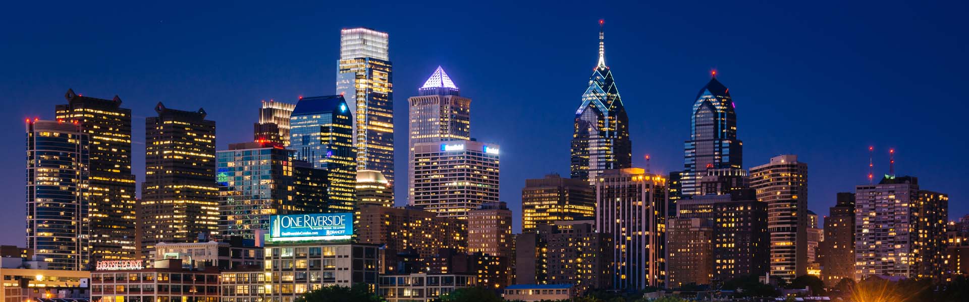 Neon color image of a band playing and people singing along