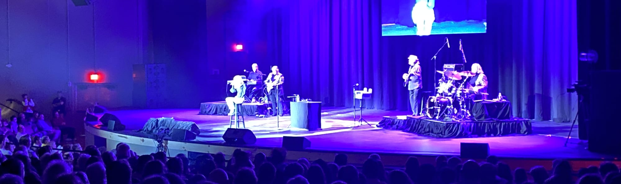 signer on stage in chair washed out by the lights Philadelphia